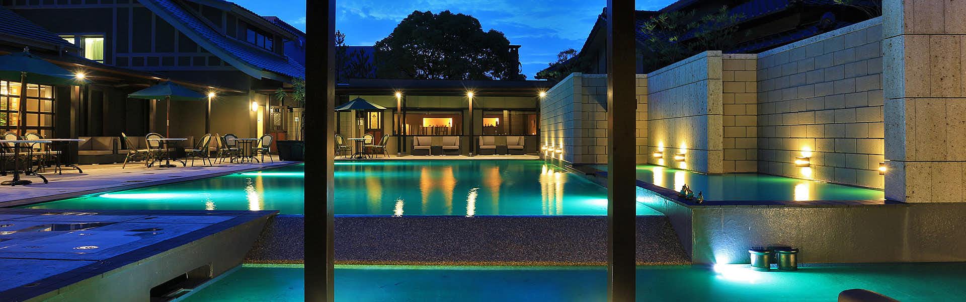 AMANE RESORT GAHAMA (Gahama Terrace) with an illuminated pool surrounded by modern villas.