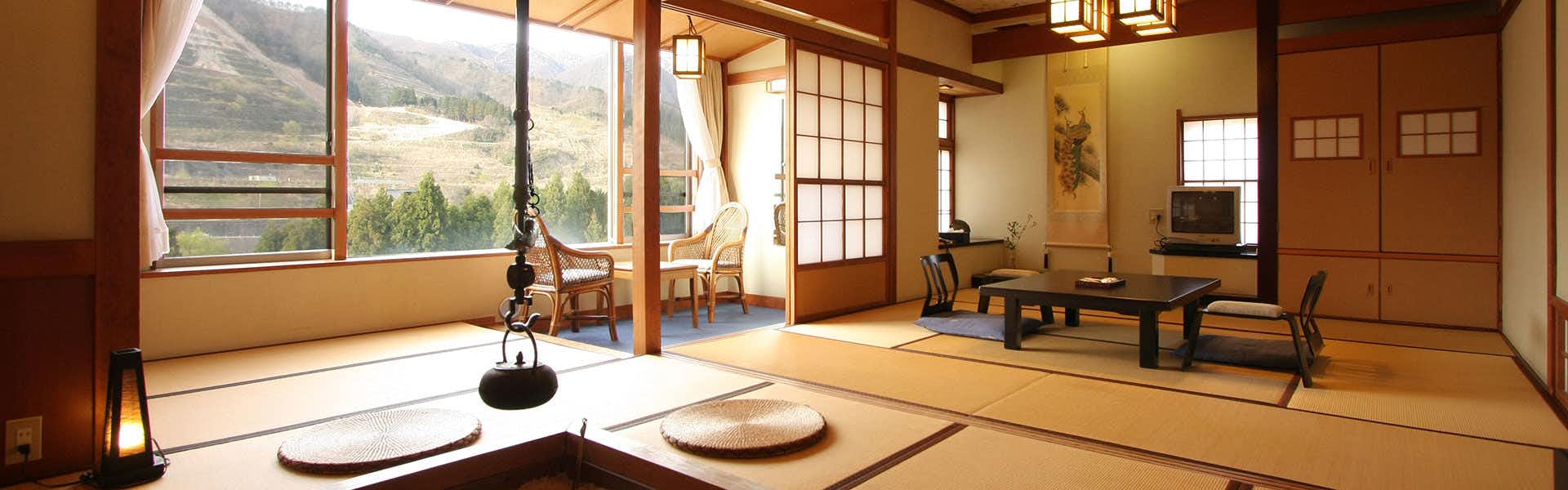 Sakihana Onsen Bokukaku with a traditional tatami room with river-facing windows.