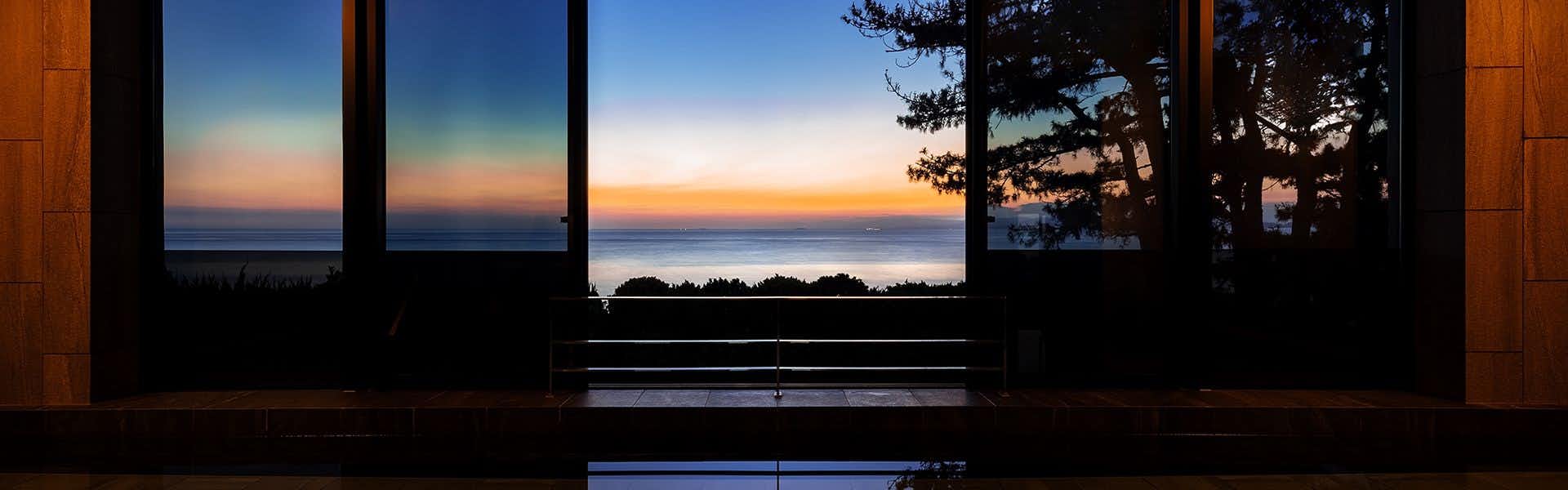 Awaji International Hotel The Sunplaza with the dark sea horizon glowing beneath a sunset sky.