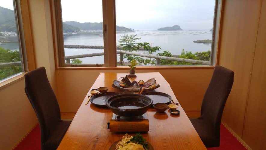 Choka no Yado Takahira with a private dining table overlooking the bright coastal bay.