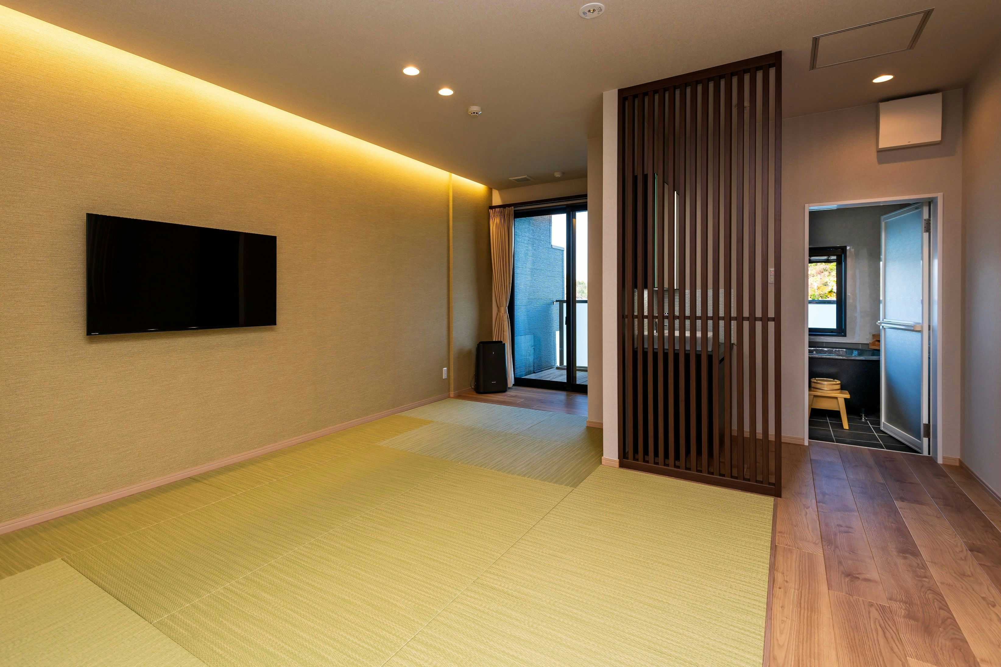 Matsushima Onsen Amakusa Nagisatei with a spacious modern tatami lounge with wall-mounted television.