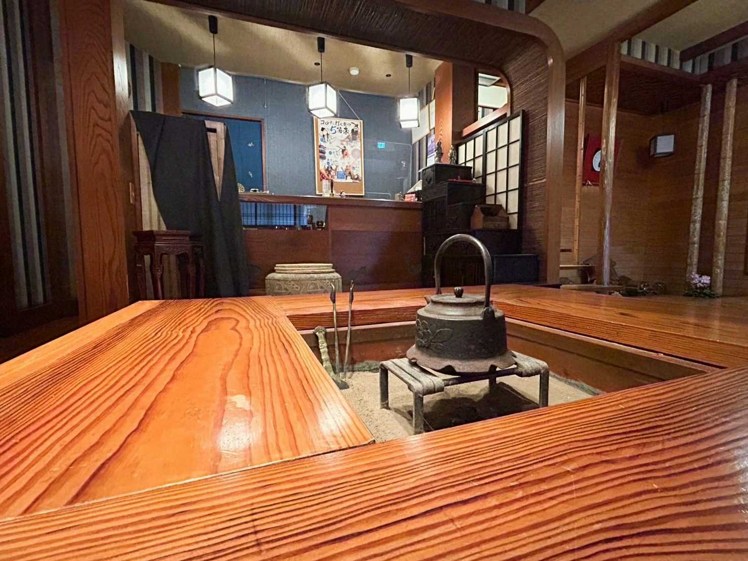 Sankai Ryokan with a rustic dining room centered on an iron hearth.