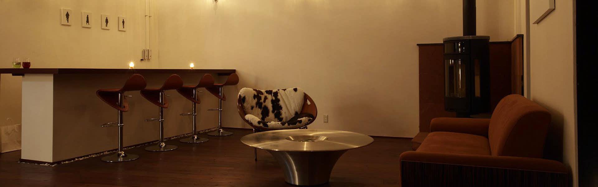 Yufu no Yu YURI lounge with bar stools, sofas and a sculptural metal table