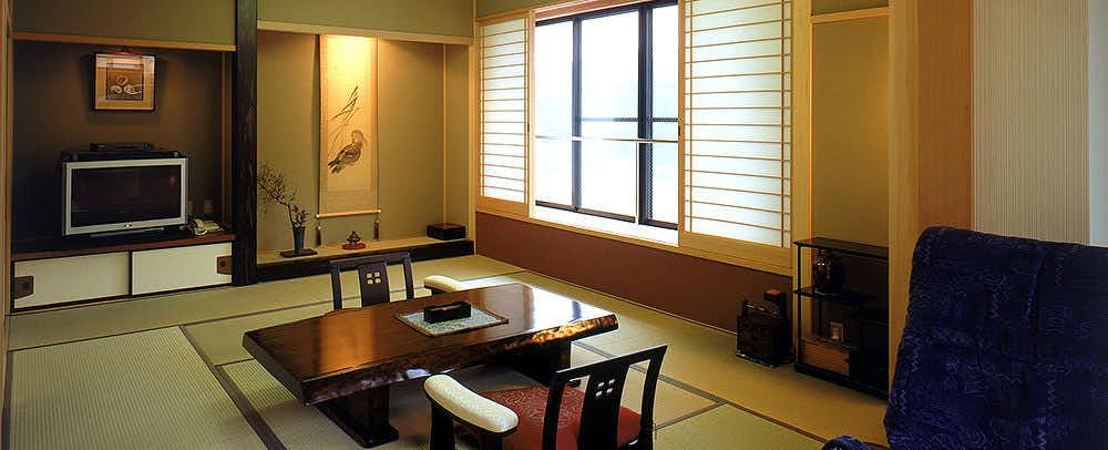 Nichouan Keigetsu with a quiet tatami room with low table and blue armchair.