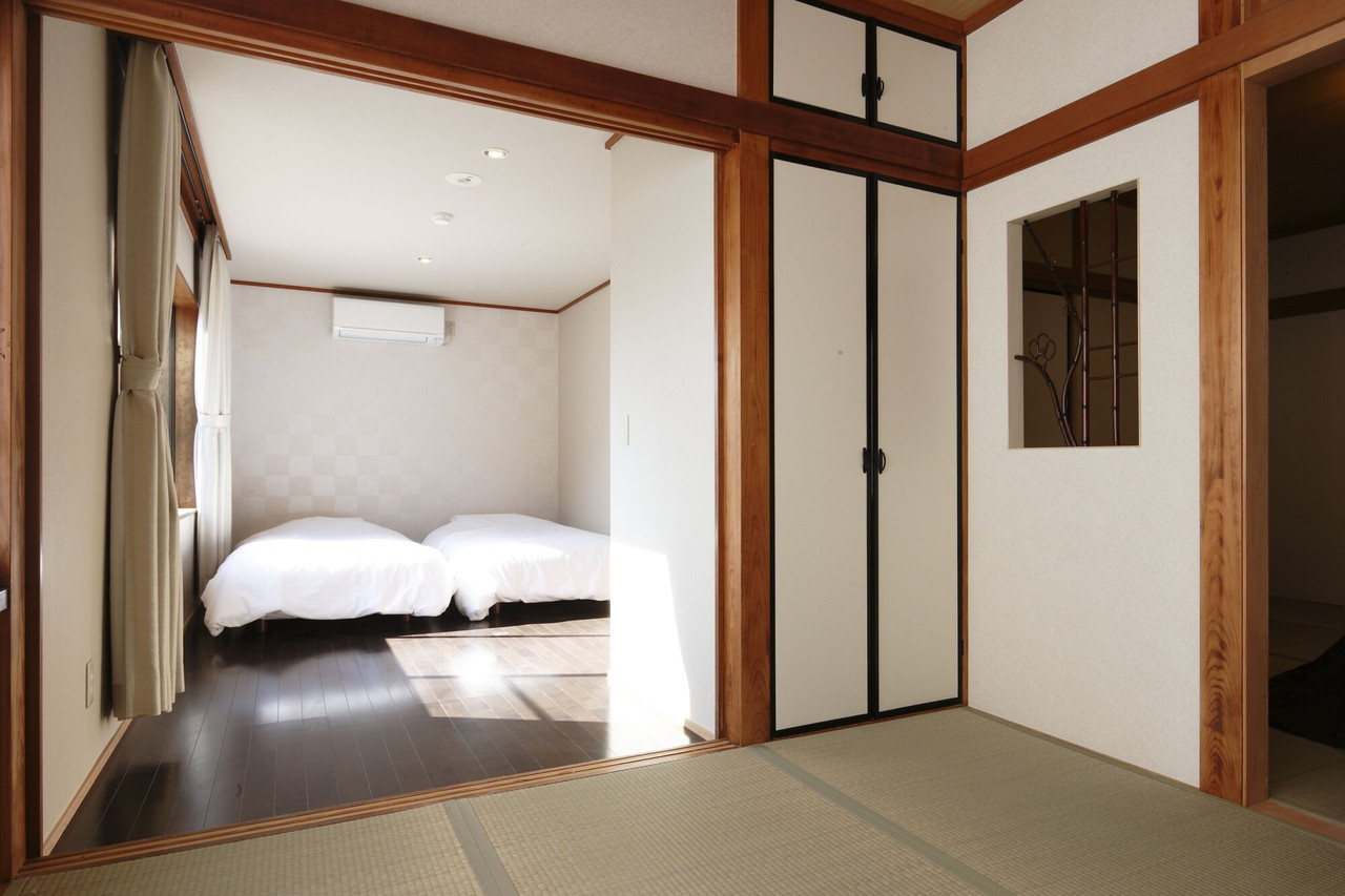 Guest room with beds and a doorway.