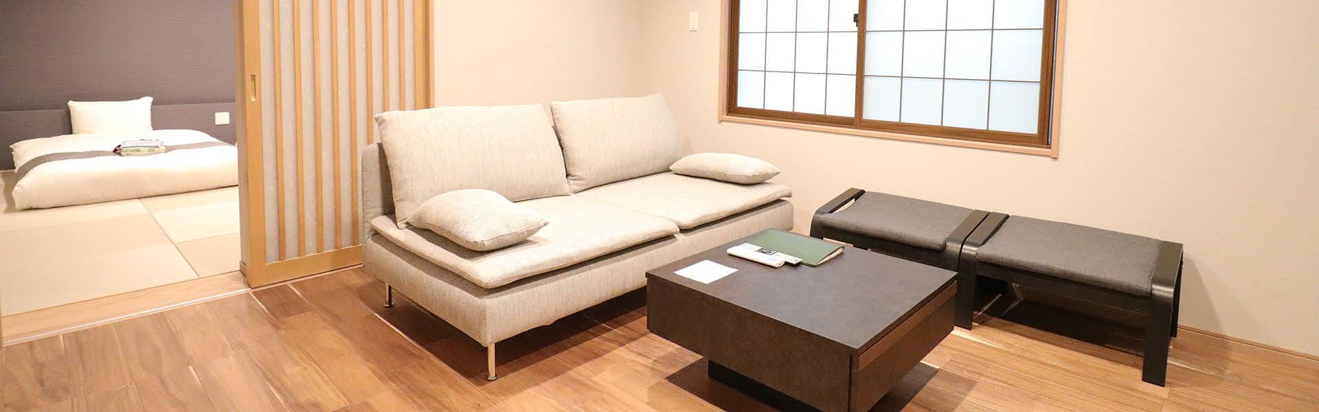 Sawando Onsen Kamikochi Hotel with a modern guest lounge with sofas and shoji windows.