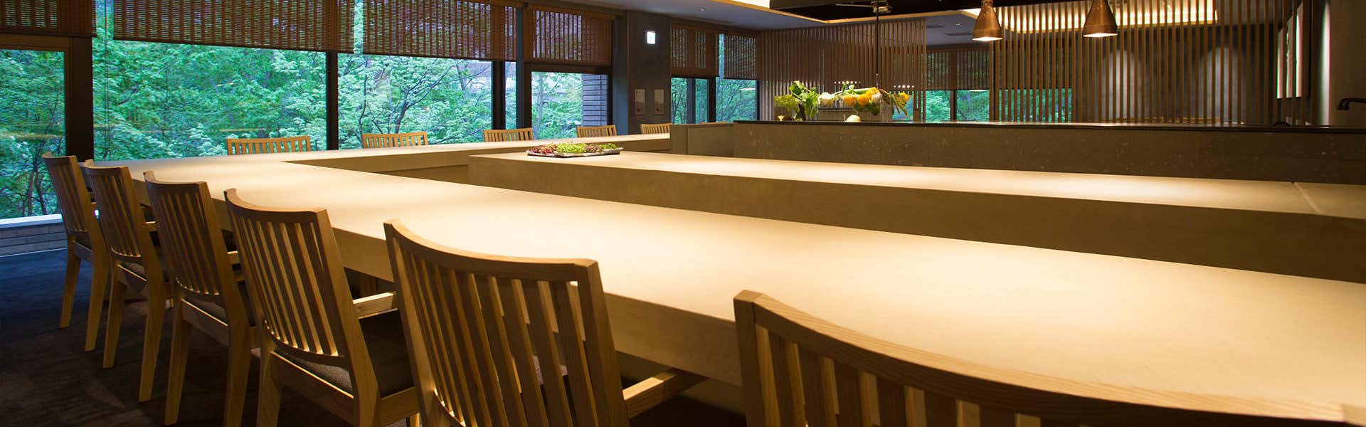 Chusui Mountain with a long timber dining counter overlooking forest greenery.
