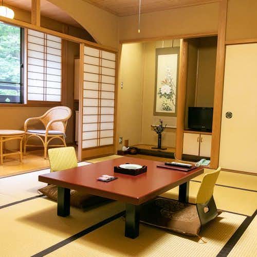 Shima Onsen Mikiya Ryokan with a compact tatami room with red low table and window chair.