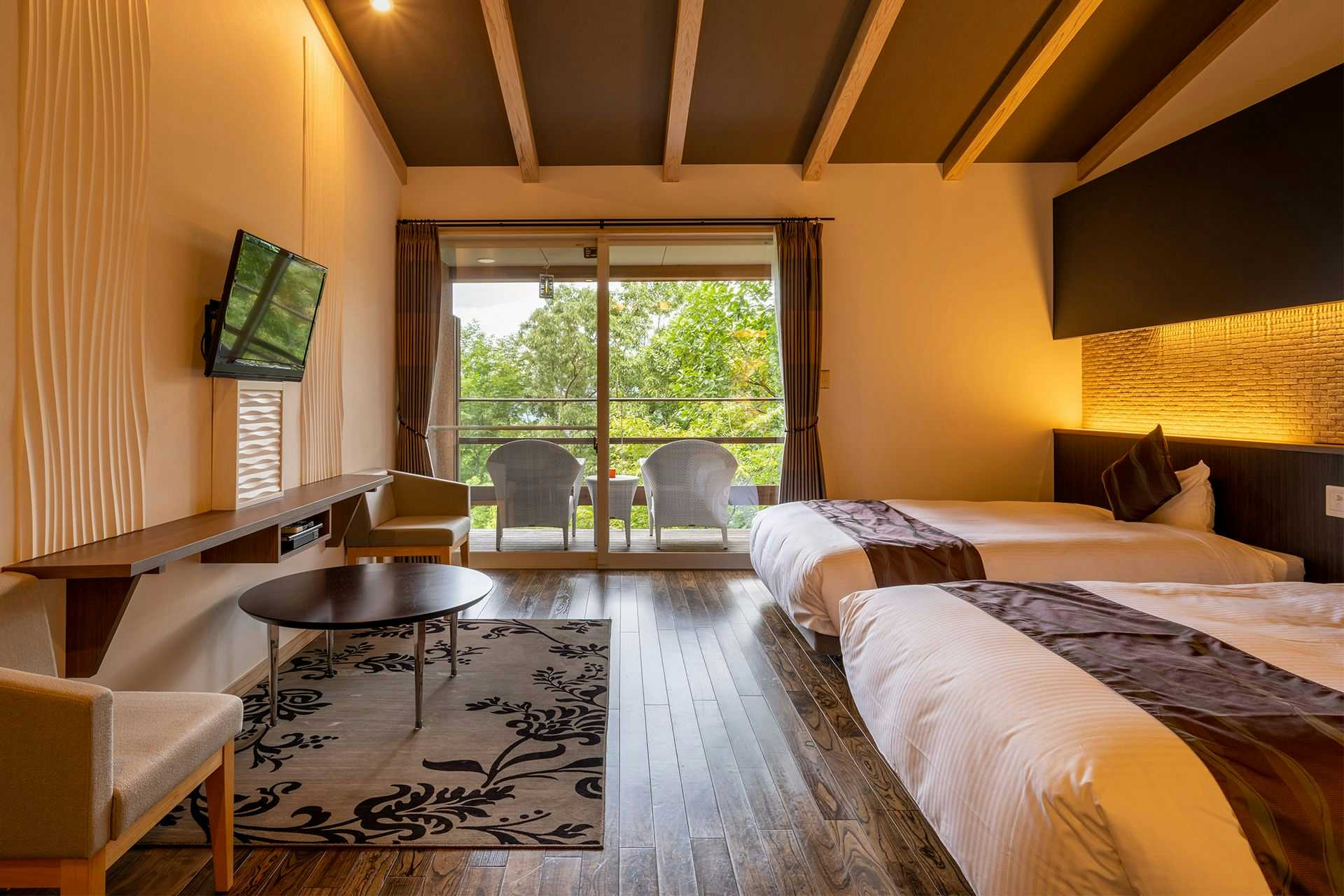 Grass Roof Inn Ryunohige / Villa Yumuta with a spacious modern suite opening onto a mountain balcony.