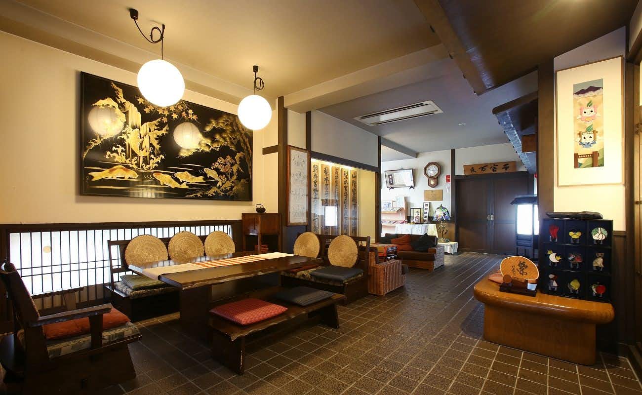 Kisoji no Yado Iwaya with a welcoming lobby with round lanterns and carved timber furniture.
