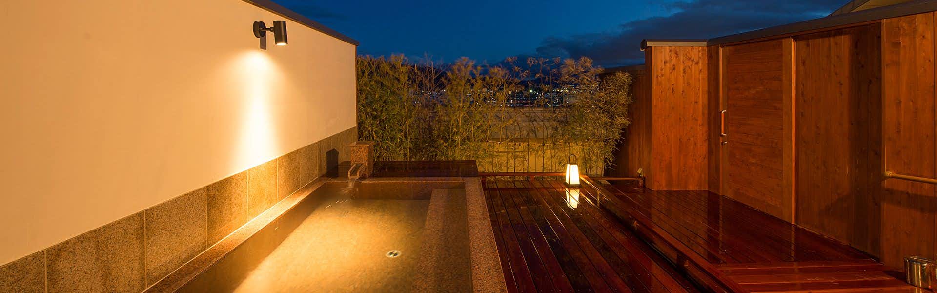 Asama Onsen Hotel Tamanoyu with a private outdoor bath overlooking city lights.