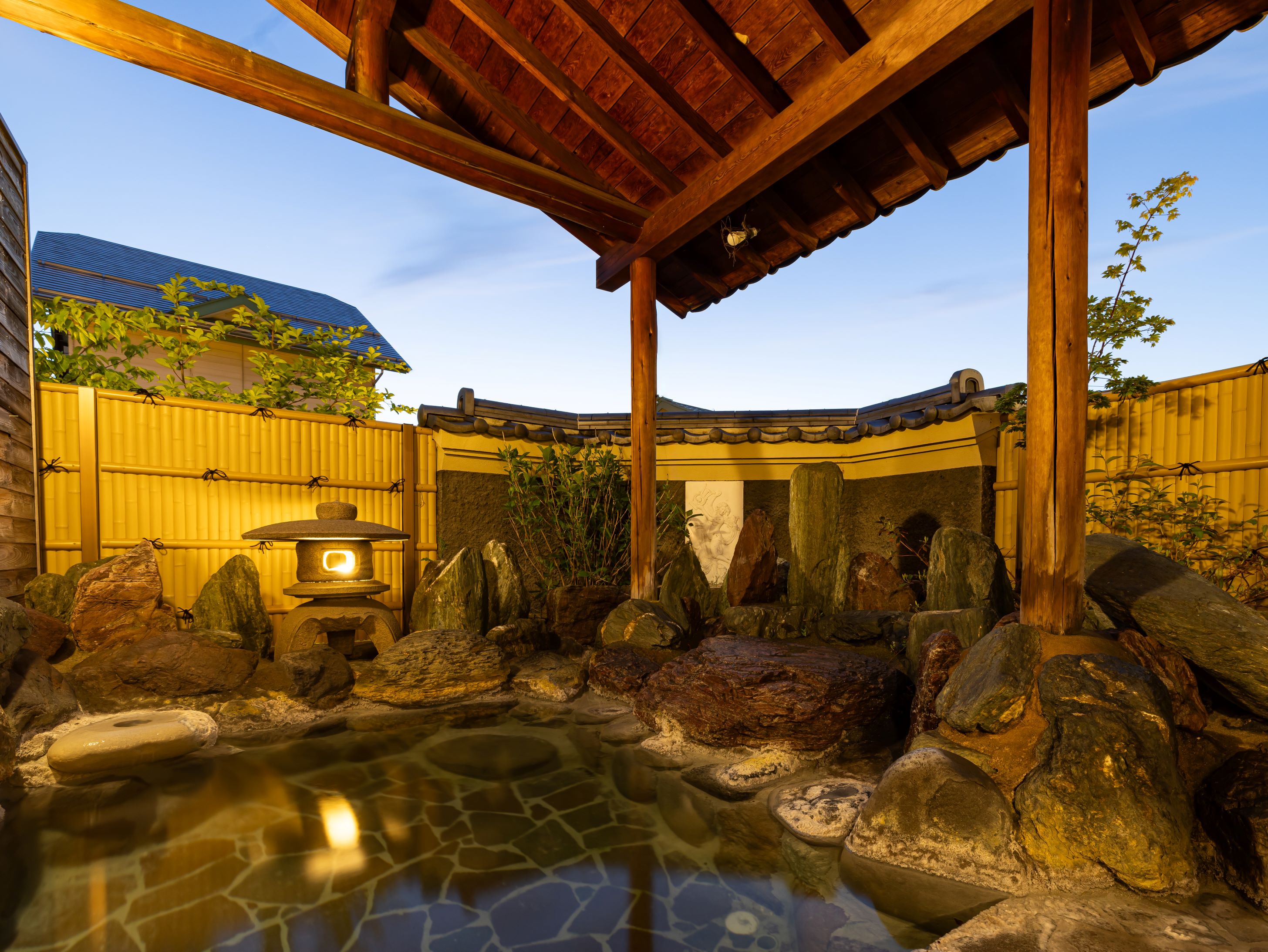 A sheltered outdoor pool is framed by timber and a mountain view.