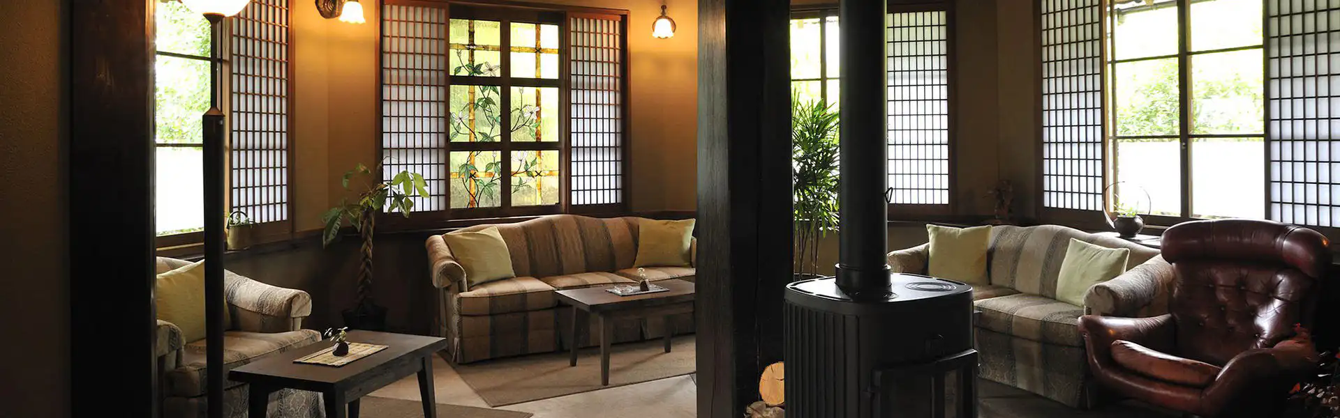 Oyado Kaikatei with this scene, where its main-house lounge surrounds a black wood-burning stove.