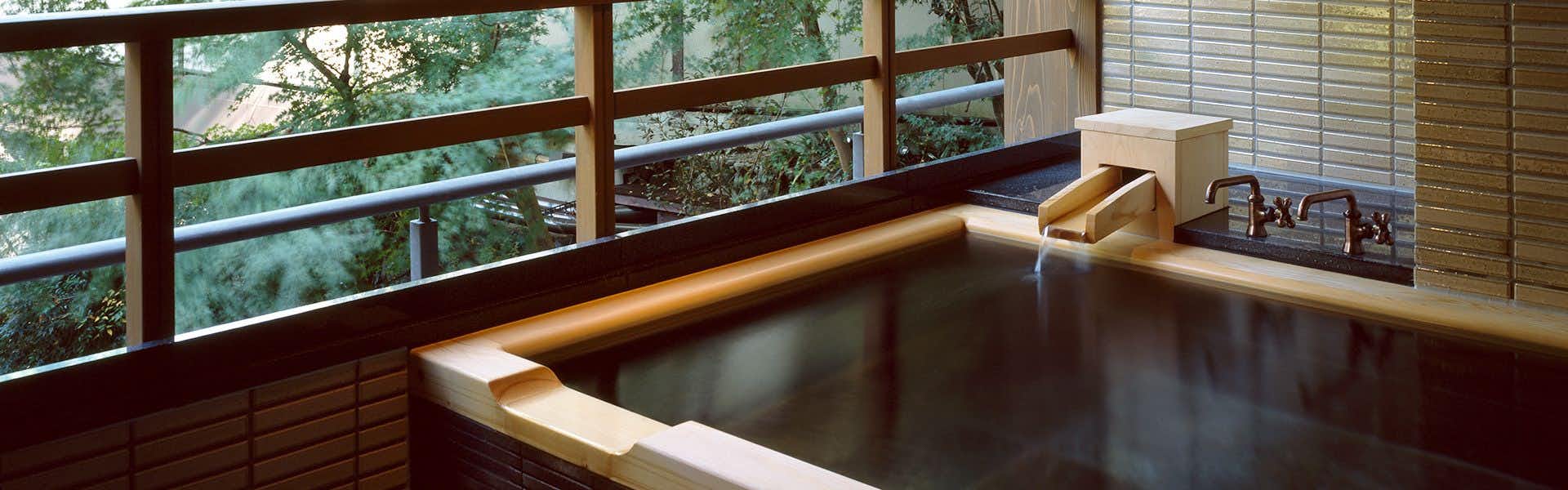 Kyoto Yunohana Onsen Sumiya Kiho-an with a private timber bath overlooking dense green forest.