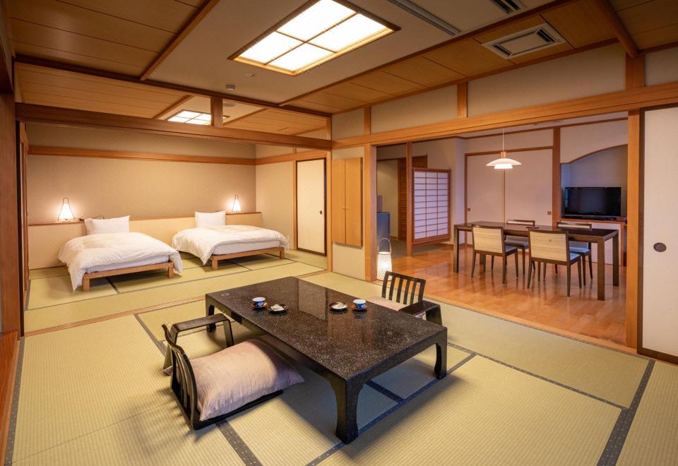 A Japanese room with twin beds and a sitting area.