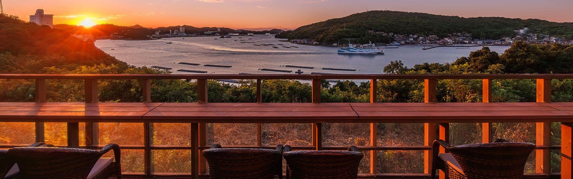 Kisara Villa Toki with a sunset panorama viewed from the broad timber terrace.
