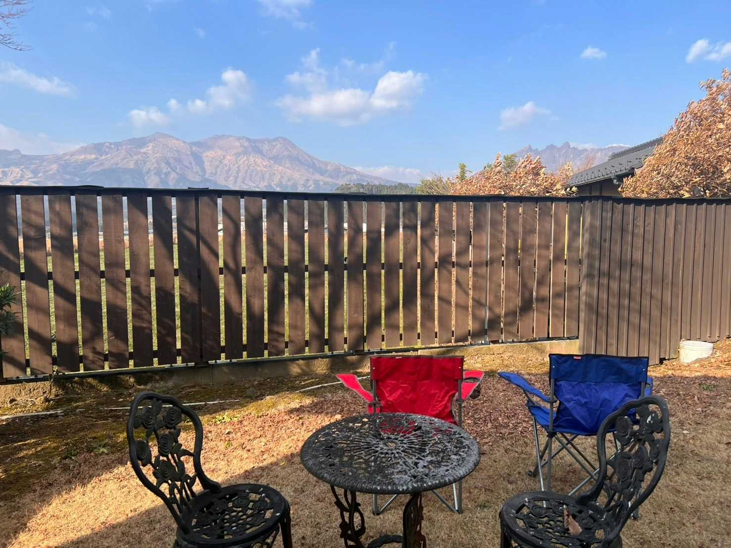 Oyado Daikonya: A private terrace with metal seating and mountain views.
