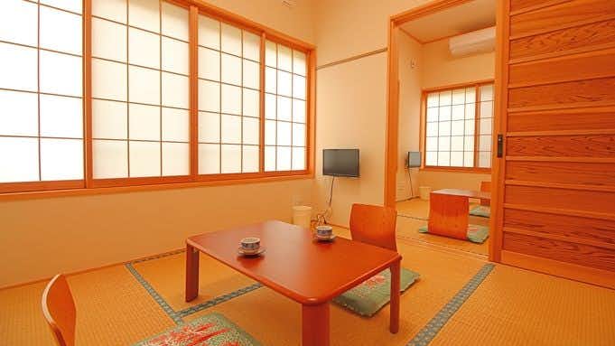Takinoyu Ryokan with a compact tatami room with low table and shoji doors.