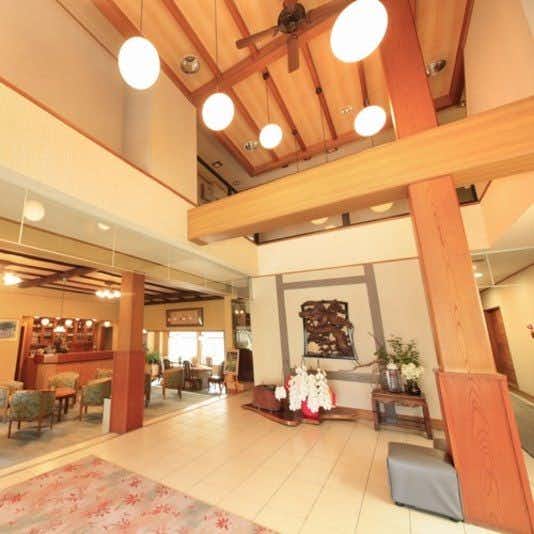 Shouhaku-kan tall timber lobby with pendant lamps and open seating areas