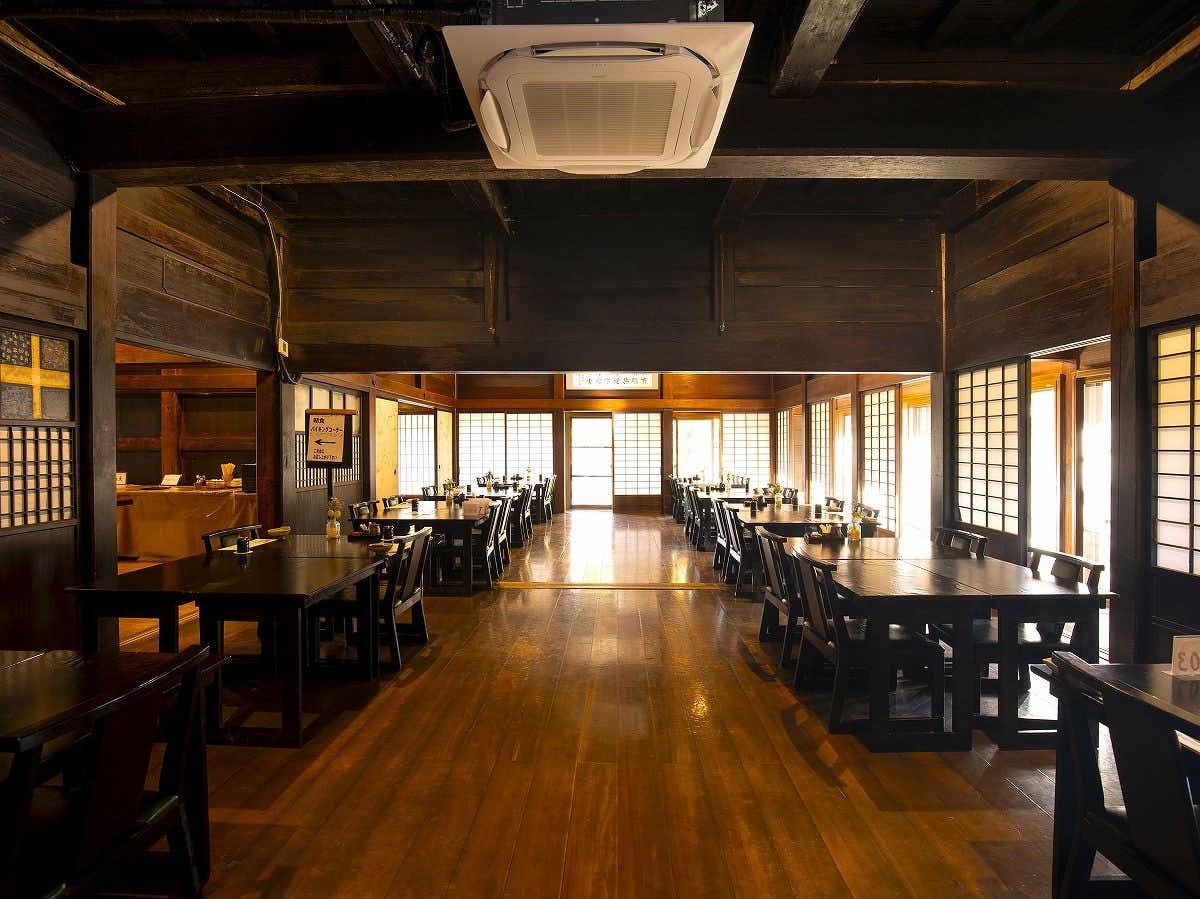 Sansou Shikian with a long timber dining hall lined with dark chairs.