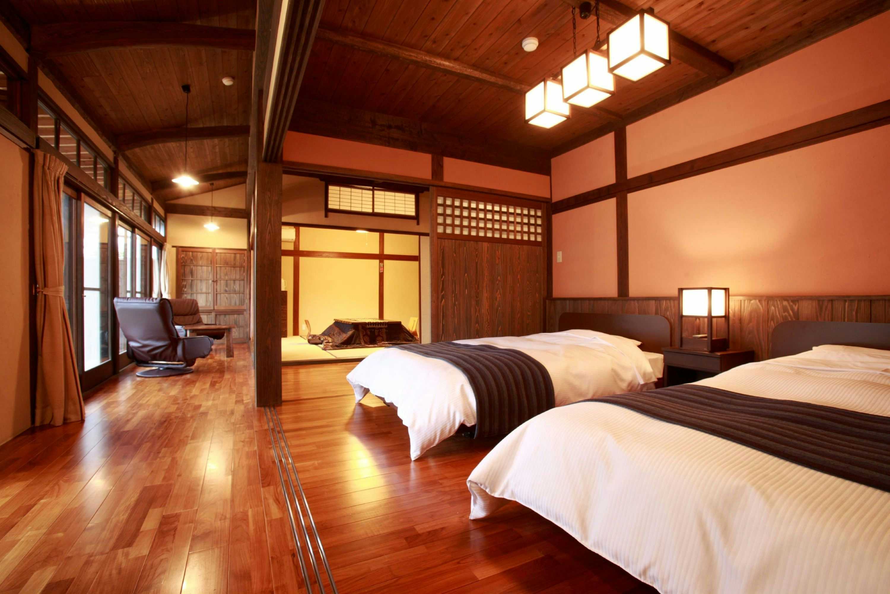 Shoen wood-paneled bedroom with twin beds and an adjoining tatami sitting space