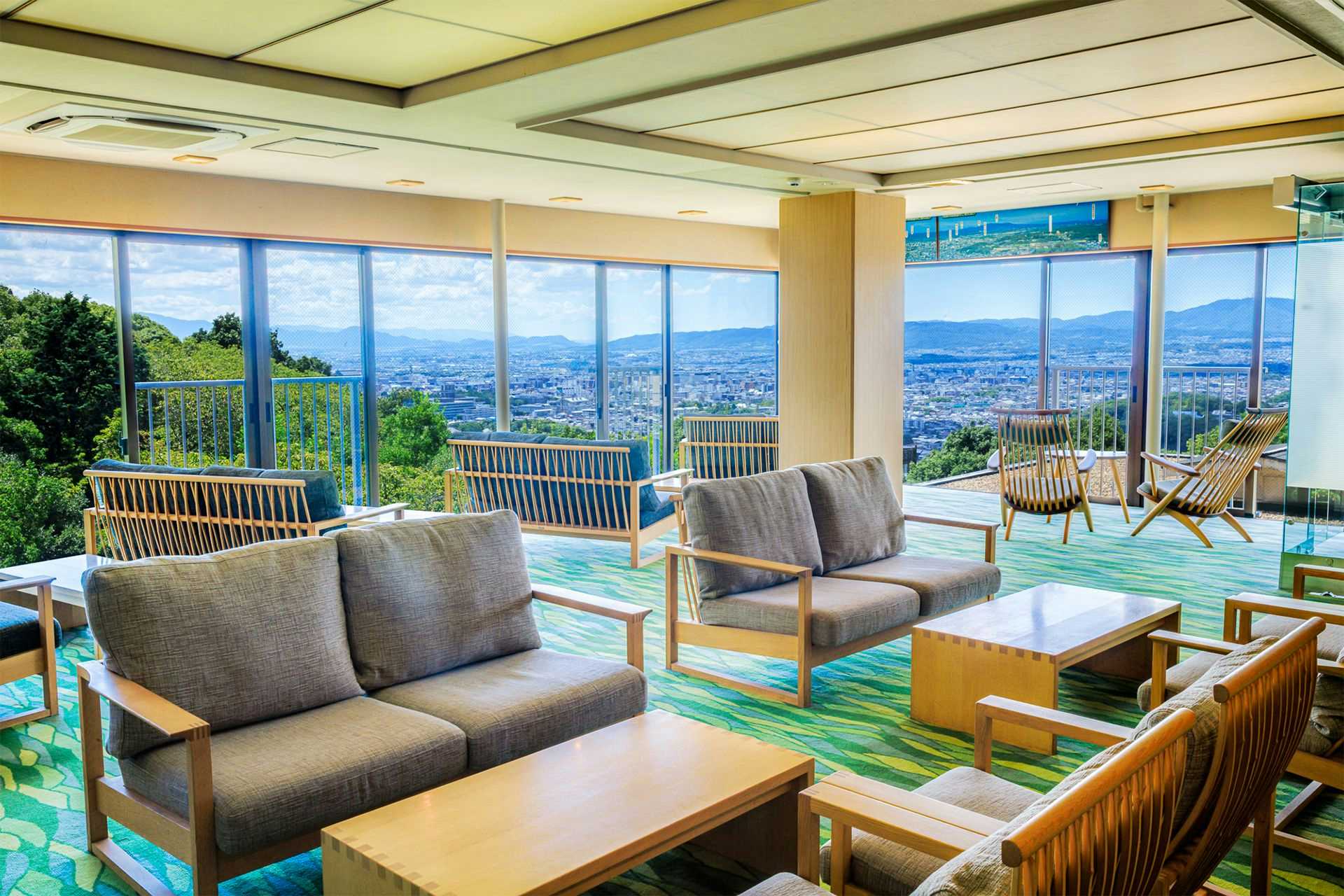 Nara Manyo Wakakusa no Yado Mikasa with a bright lounge overlooking Nara and distant mountains.