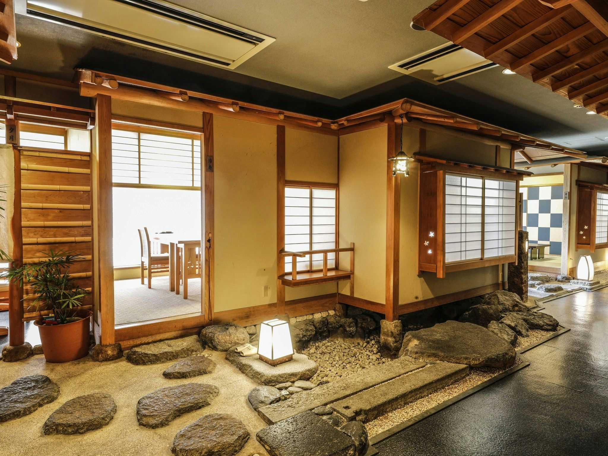 Matsue Shinjiko Onsen Ohashikan with a traditional lobby arranged around a small stone garden.