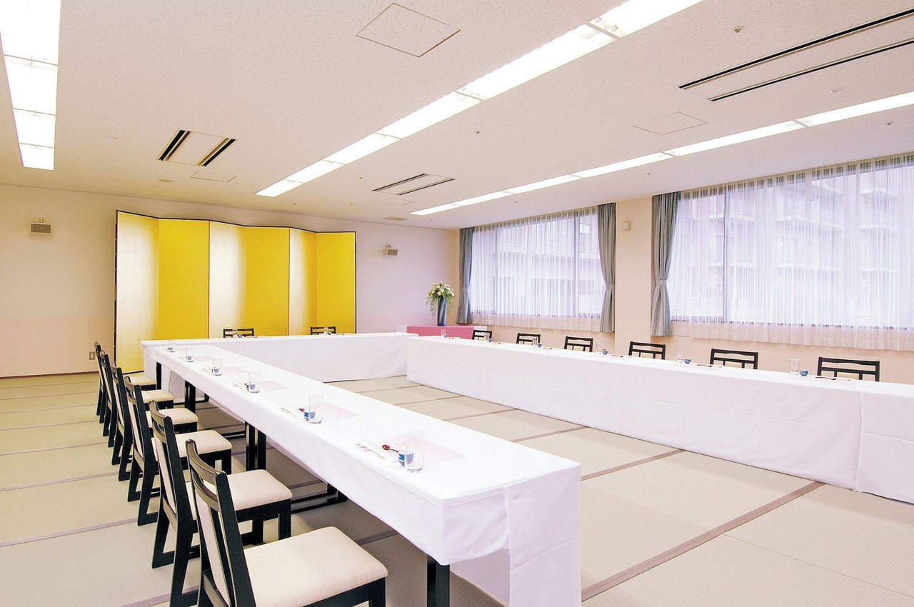Banquet room with long tables.