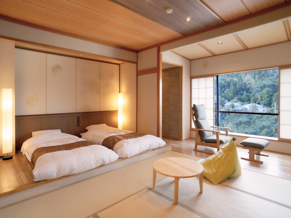 Tatami guest room with futon bedding and a window-side sitting area.