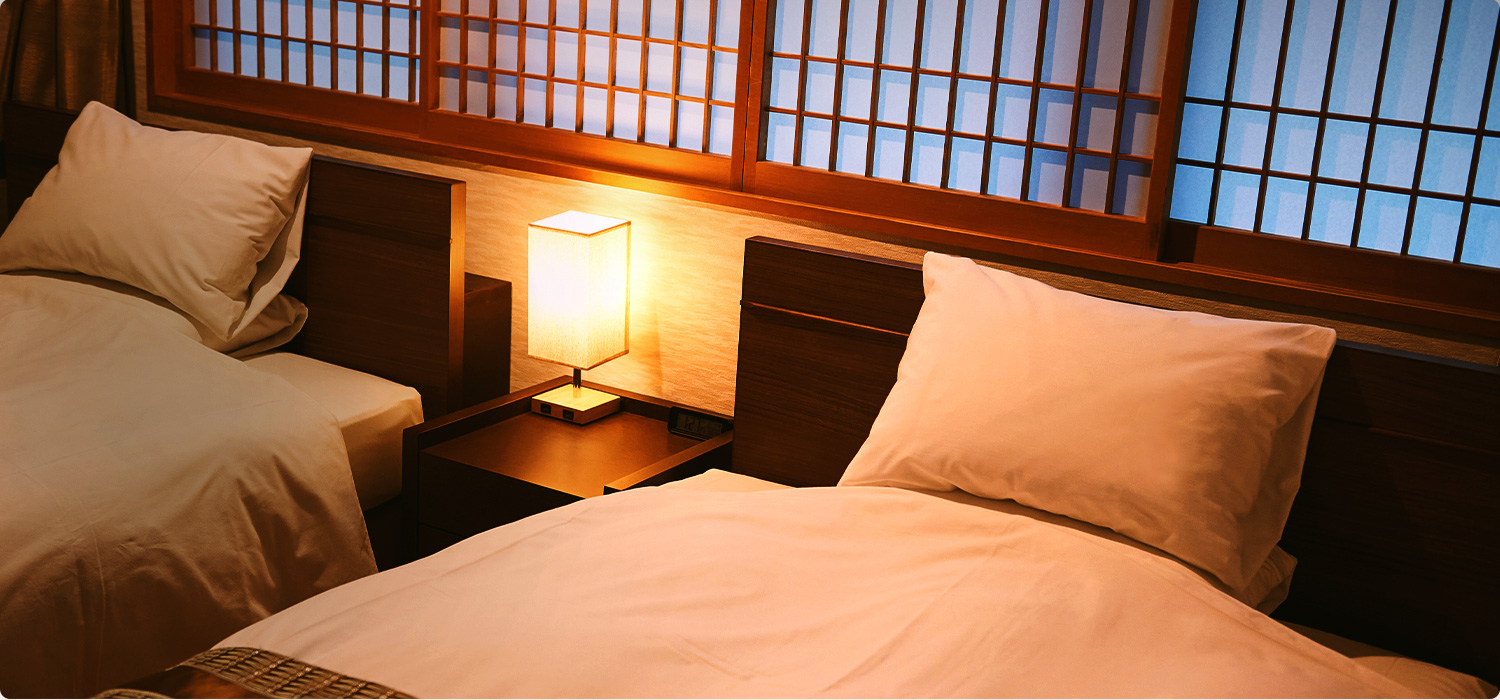 Twin guest room with warm wood detailing.