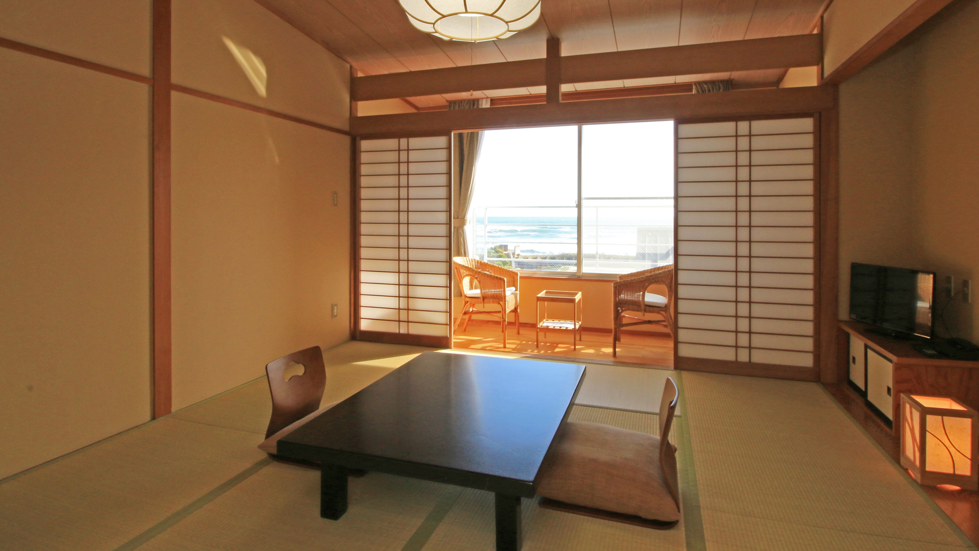 A tatami room with a low table and a window-side sitting area.