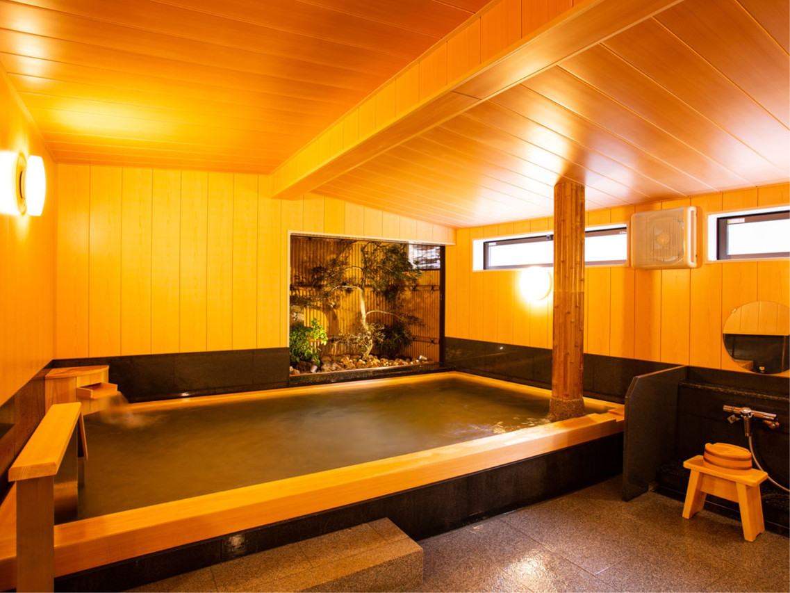 Indoor bath with a garden feature.