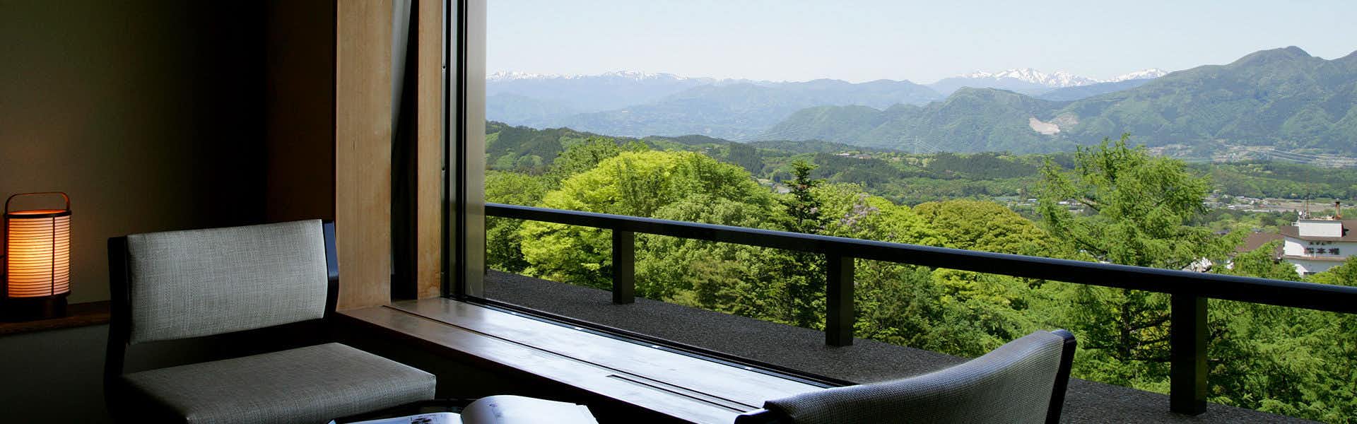 Ikaho Onsen Ichikawa Annex Seikansou with a quiet lounge facing forested hills.