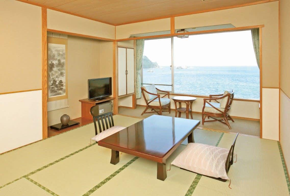 Araisō Onsen Araisōkan with a traditional tatami room with low table and ocean balcony.