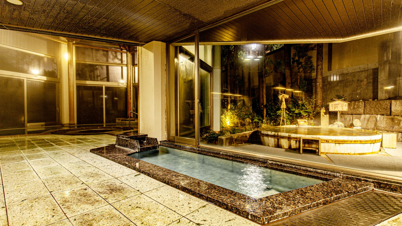 A large indoor bath with a water feature.