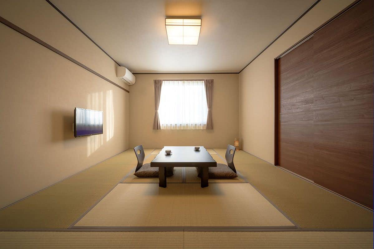 Ryokan Maizuru with a minimalist tatami room with low table and soft lighting.