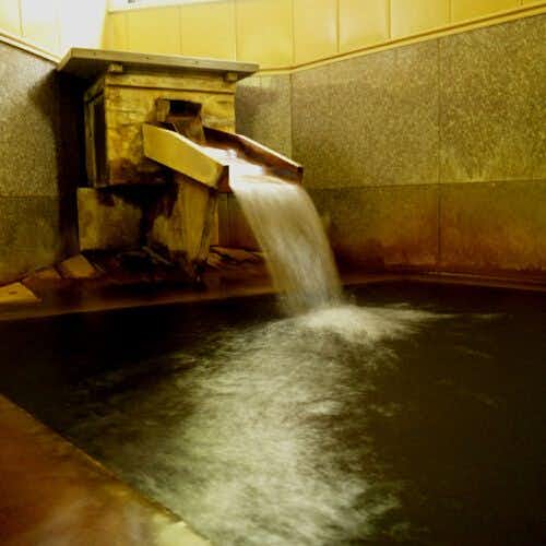Togatta Onsen Tamaya Ryokan with mineral water flowing into a warm stone bath.
