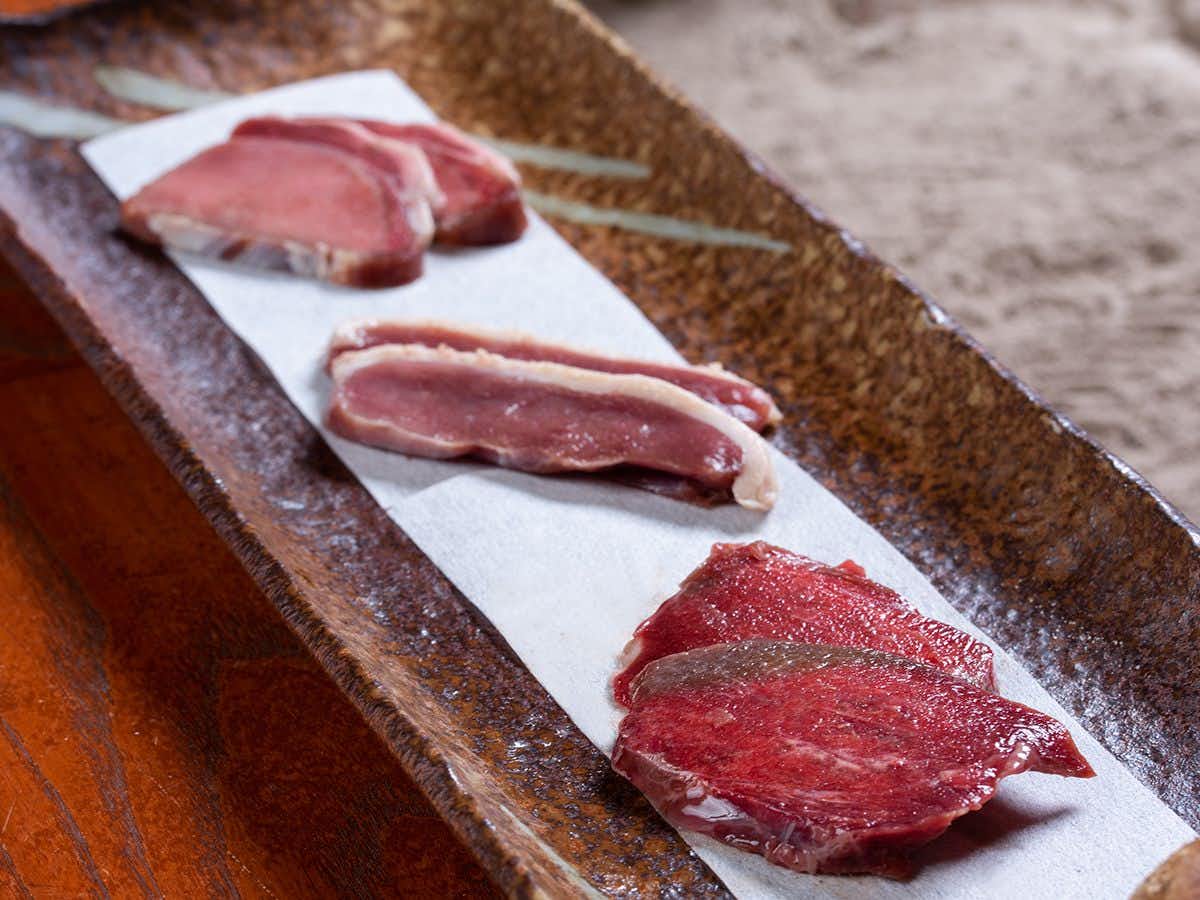 Kiyotsu Gorge Hotel Setoguchi with three cuts of local meat displayed on a stone slab.
