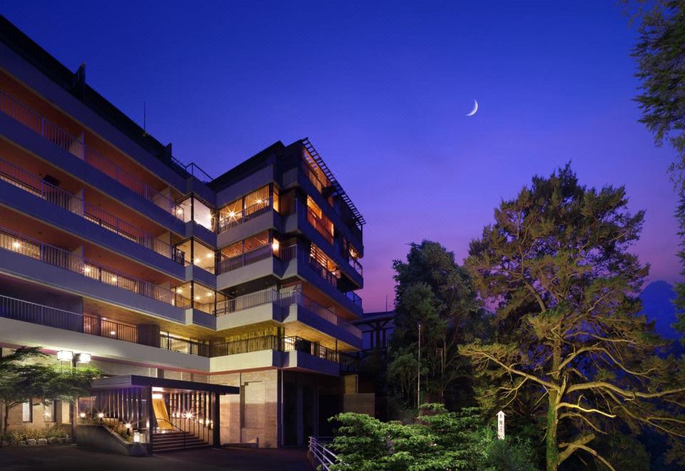 A hotel building lit at dusk.
