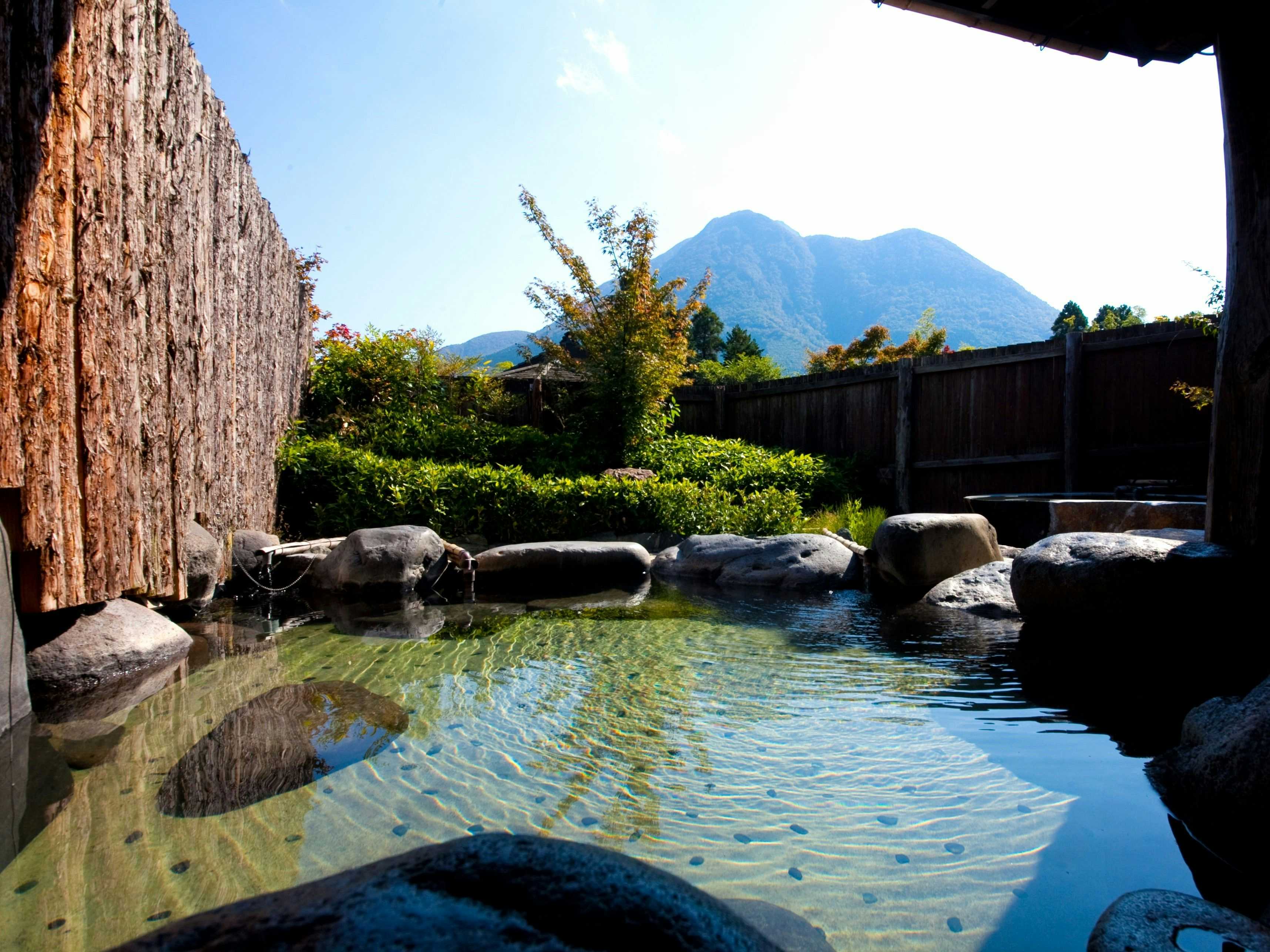 Sansou Shikian with an outdoor stone bath overlooking the mountain landscape.