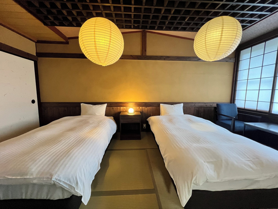 Twin beds beneath a wood-beamed ceiling.