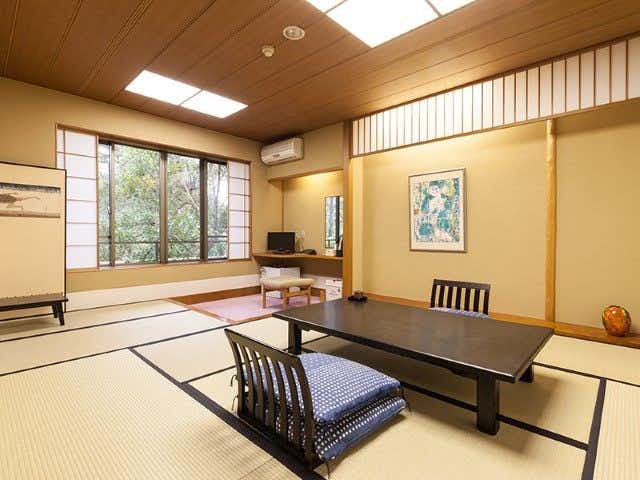 Ryoutei Ryokan Oarai Yamaguchirou with a traditional tatami room with low table and garden window.