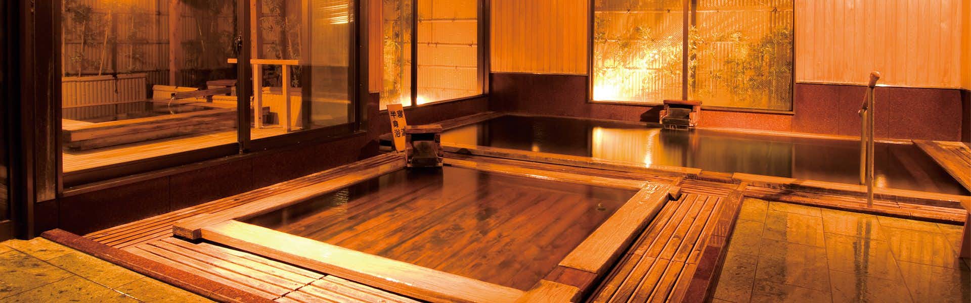 Hotel Kameya Honten with a warm indoor bath built with rectangular timber tubs.