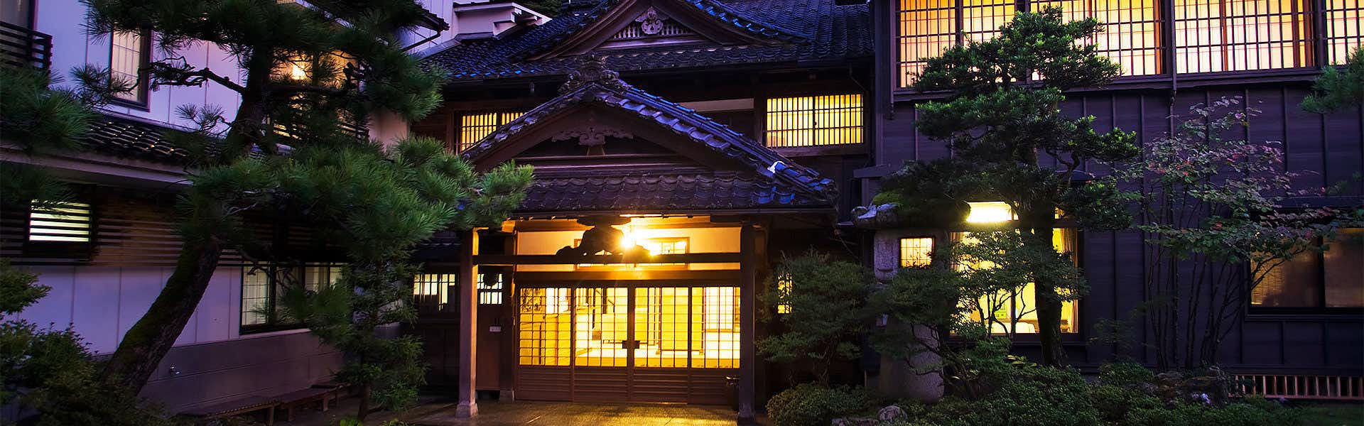 Kanazawa Fukatani Onsen Motoyu Ishiya - A Secluded Inn with a Noh Stage traditional lodging entrance illuminated at dusk