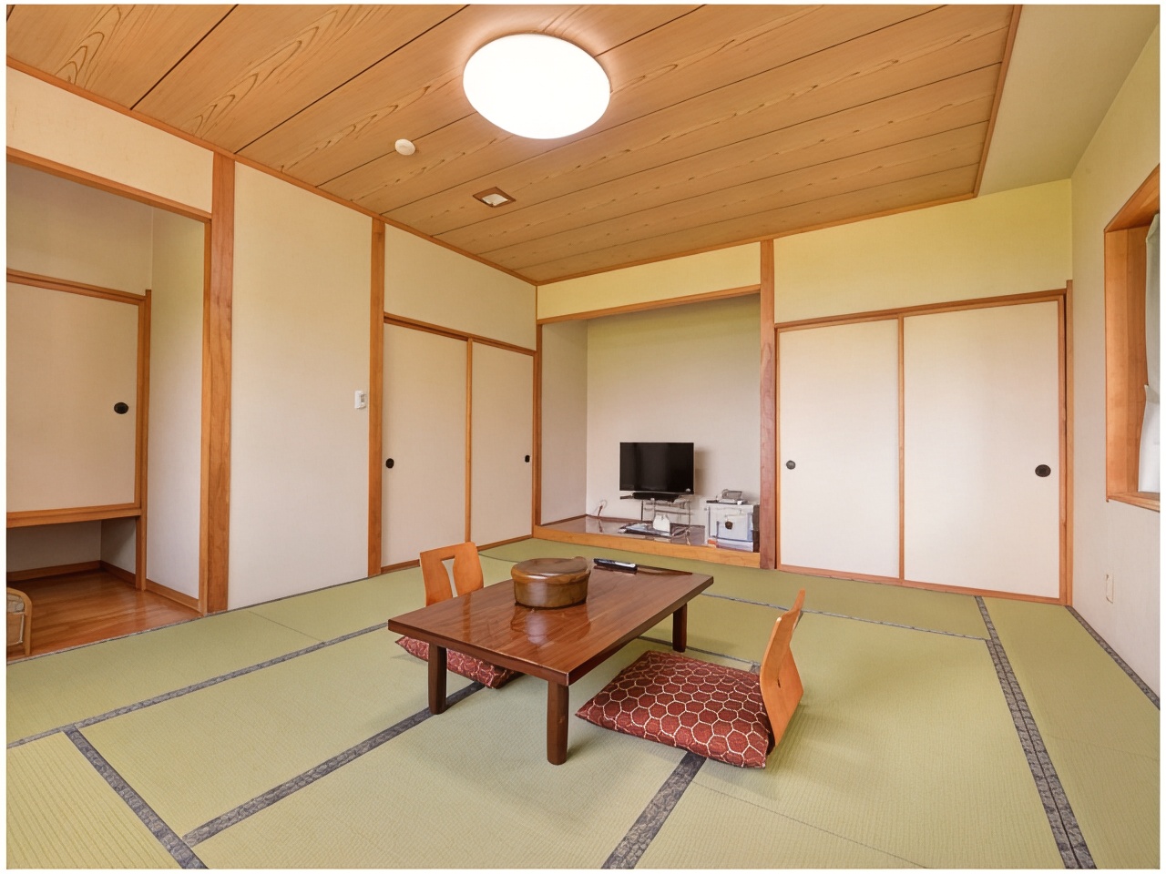 Tatami room with a low table and sliding doors.