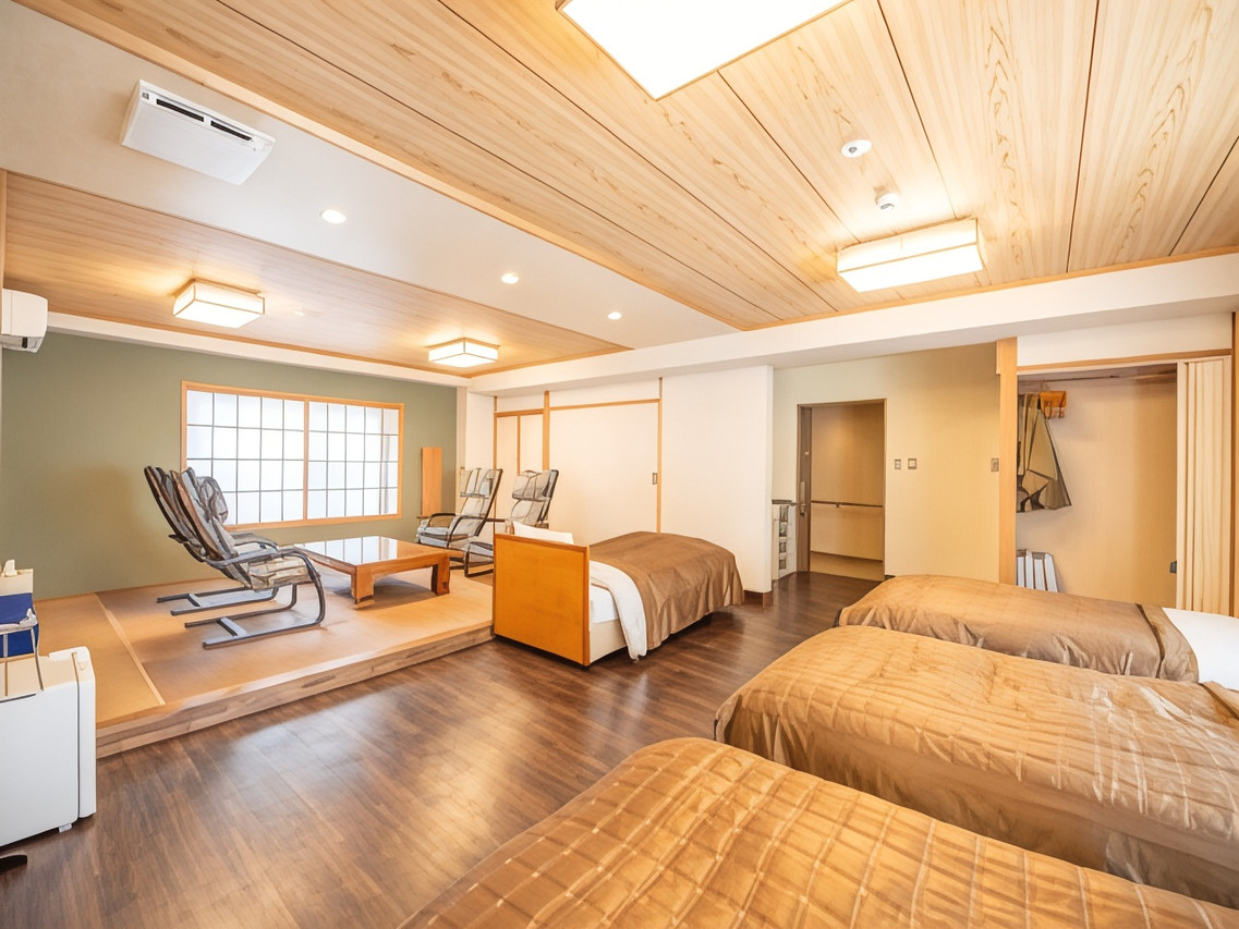 A bright room with beds and a low table.