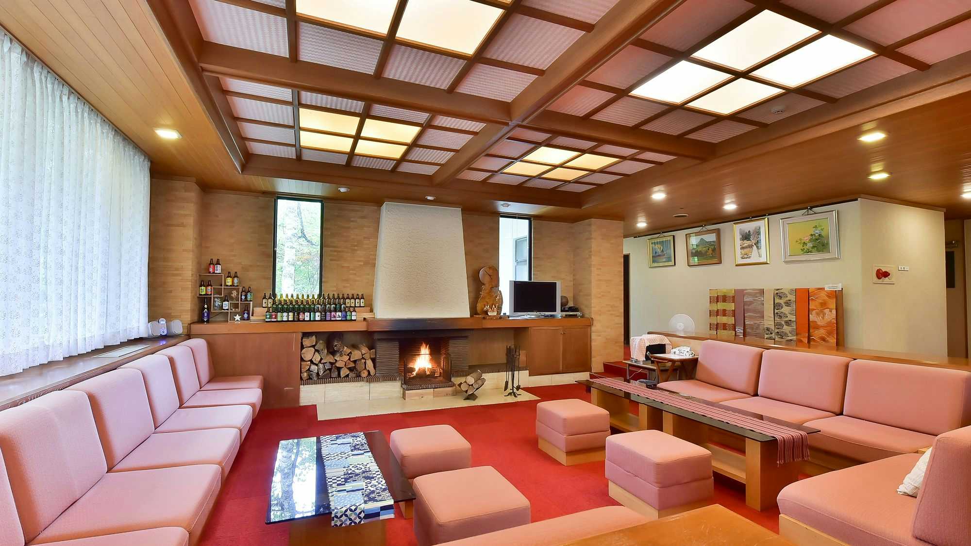 Fudoson no Yu Onjuku Kotobuki with a spacious lobby with pink sofas and central fireplace.