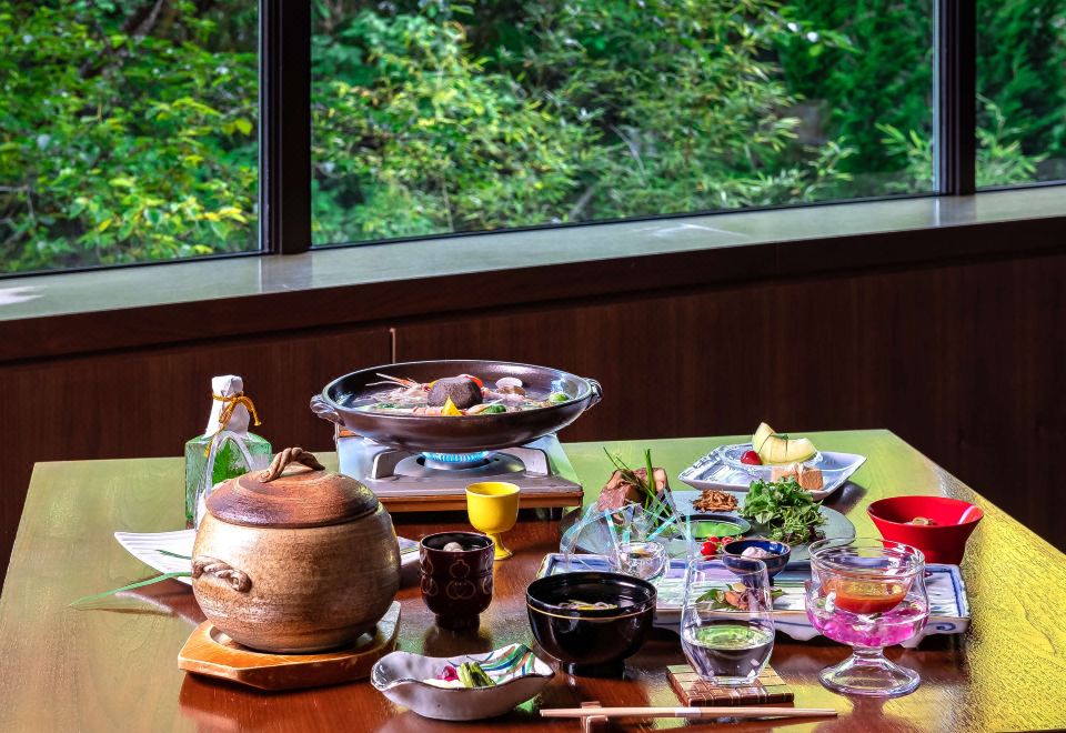 Meal set beside a forest view.