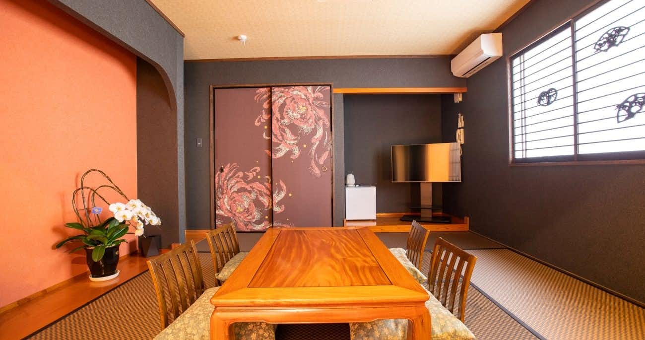 Ryokan Hitaya with a private dining room with long timber table and pink walls.