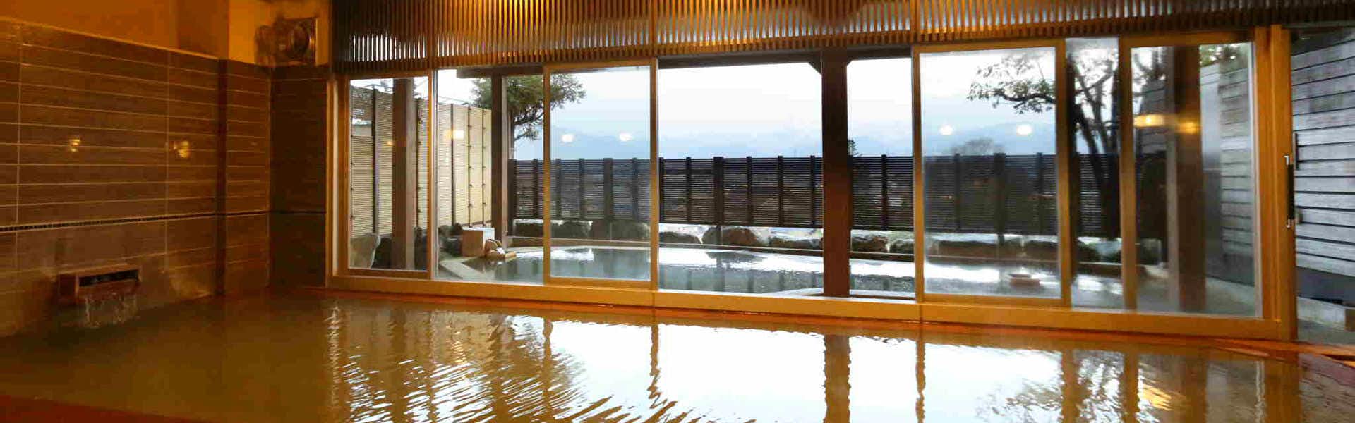 Fukumitsu Hanayama Onsen large indoor bath beside glass doors to an outdoor bath